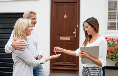 Agent Giving Key to Couple